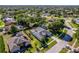 Beautiful aerial view of a home featuring a well-manicured lawn, mature landscaping and a welcoming entrance at 4044 Chesterfield Dr, Spring Hill, FL 34609
