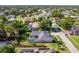 Stunning aerial view of a home featuring a screened pool, well-maintained lawn and mature trees at 4044 Chesterfield Dr, Spring Hill, FL 34609