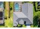 Aerial view of a home featuring a private screened-in pool and lush backyard at 4044 Chesterfield Dr, Spring Hill, FL 34609