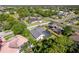 Beautiful aerial view of a home with a screened pool and lush landscaping in a vibrant neighborhood at 4044 Chesterfield Dr, Spring Hill, FL 34609