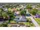 Stunning aerial view of a home featuring a screened pool, well-maintained lawn and mature trees at 4044 Chesterfield Dr, Spring Hill, FL 34609