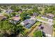 Beautiful aerial view of a home featuring a well-manicured lawn, mature landscaping and a welcoming entrance at 4044 Chesterfield Dr, Spring Hill, FL 34609