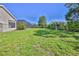 This large backyard features a screened-in pool and lush green grass, ideal for outdoor activities and relaxation at 4044 Chesterfield Dr, Spring Hill, FL 34609