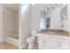 Well-lit bathroom featuring a vanity with granite countertop, toilet, and a tiled shower-tub combination at 4044 Chesterfield Dr, Spring Hill, FL 34609