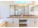 Bright bathroom featuring a large mirror and granite countertops with dual sinks and vanity seating at 4044 Chesterfield Dr, Spring Hill, FL 34609