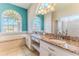 Bright bathroom featuring a large soaking tub, glass shower, and granite countertops with dual sinks at 4044 Chesterfield Dr, Spring Hill, FL 34609
