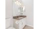 Well-lit bathroom featuring a vanity with granite countertop and toilet at 4044 Chesterfield Dr, Spring Hill, FL 34609