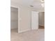 Bedroom featuring neutral carpet, a door to a closet, and a ceiling fan at 4044 Chesterfield Dr, Spring Hill, FL 34609