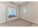 Inviting bedroom with a window, neutral carpet, and a door offering a serene and private atmosphere at 4044 Chesterfield Dr, Spring Hill, FL 34609