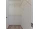 Walk-in closet with white shelving and carpeted floor at 4044 Chesterfield Dr, Spring Hill, FL 34609