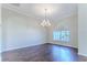 Bright dining room features hardwood floors, arched window, and elegant chandelier fixture at 4044 Chesterfield Dr, Spring Hill, FL 34609