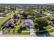 Beautiful aerial view of a home featuring a well-manicured lawn, mature landscaping and a welcoming entrance at 4044 Chesterfield Dr, Spring Hill, FL 34609