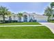 Charming single-story home with well-manicured lawn and lush landscaping at 4044 Chesterfield Dr, Spring Hill, FL 34609