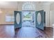 Open double-door entry and high ceilings with hardwood flooring at 4044 Chesterfield Dr, Spring Hill, FL 34609