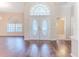Bright foyer featuring white double doors, arch window, and wood floors at 4044 Chesterfield Dr, Spring Hill, FL 34609