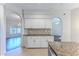 Charming kitchen area with white cabinets, granite countertops, and an open layout to other living spaces at 4044 Chesterfield Dr, Spring Hill, FL 34609