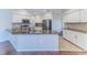 Modern kitchen with stainless steel appliances, granite countertops, white cabinetry, and tile flooring at 4044 Chesterfield Dr, Spring Hill, FL 34609