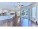 Spacious living room with hardwood floors connects seamlessly to the kitchen and outdoor patio area at 4044 Chesterfield Dr, Spring Hill, FL 34609