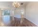 Open-concept living room features hardwood floors, neutral paint, and an arched entry to the kitchen at 4044 Chesterfield Dr, Spring Hill, FL 34609