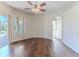 Bright living room featuring hardwood floors and sliding glass doors to the backyard pool area at 4044 Chesterfield Dr, Spring Hill, FL 34609