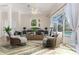 Bright living room with neutral paint features a ceiling fan, comfortable seating, and large windows at 4044 Chesterfield Dr, Spring Hill, FL 34609