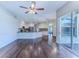 Open living space showcasing hardwood floors, a kitchen area, and access to an outdoor patio at 4044 Chesterfield Dr, Spring Hill, FL 34609