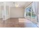 Bright living room features hardwood floors, neutral paint, access to the pool, and a ceiling fan at 4044 Chesterfield Dr, Spring Hill, FL 34609