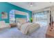 Bright main bedroom showcasing pool view through sliding glass doors and unique arched windows for abundant natural light at 4044 Chesterfield Dr, Spring Hill, FL 34609