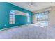 Bright main bedroom showcasing pool view through sliding glass doors and unique arched windows for abundant natural light at 4044 Chesterfield Dr, Spring Hill, FL 34609