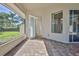 Covered patio with brick flooring and view of the backyard at 4044 Chesterfield Dr, Spring Hill, FL 34609