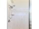 Tiled shower featuring dual shower heads, shower caddy, and glass door at 4044 Chesterfield Dr, Spring Hill, FL 34609