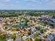 Drone shot of neighborhood and lake with surrounding homes and mature landscaping at 4315 Oakland Dr, New Port Richey, FL 34653