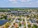 A view of the property in a residential neighborhood with mature trees and a nearby lake at 4315 Oakland Dr, New Port Richey, FL 34653