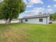A spacious backyard with lush green grass and a large tree provides ample space for outdoor activities at 4315 Oakland Dr, New Port Richey, FL 34653