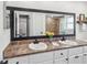 Bathroom featuring a double sink vanity with a granite countertop and large mirror at 4315 Oakland Dr, New Port Richey, FL 34653