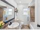 Bright bathroom showcasing a shower-tub combo, vanity, and natural light at 4315 Oakland Dr, New Port Richey, FL 34653