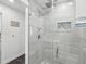 Bright bathroom featuring a glass-enclosed shower with neutral tile and decor at 4315 Oakland Dr, New Port Richey, FL 34653