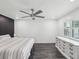 Comfortable bedroom with a ceiling fan, a dresser, and a bed with striped bedding at 4315 Oakland Dr, New Port Richey, FL 34653