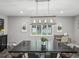 Elegant dining room featuring a large table, stylish lighting fixture, and serene window views at 4315 Oakland Dr, New Port Richey, FL 34653