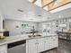 Open-concept kitchen with an island, white cabinetry, and natural wood flooring at 4315 Oakland Dr, New Port Richey, FL 34653