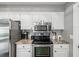 Updated kitchen with stainless steel appliances and a tile backsplash at 4315 Oakland Dr, New Port Richey, FL 34653