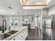 Modern kitchen featuring stainless steel appliances, an island with marble countertops, and wood floors at 4315 Oakland Dr, New Port Richey, FL 34653