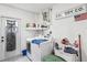 Well-organized laundry room equipped with a washer, dryer, and ample storage shelves at 4315 Oakland Dr, New Port Richey, FL 34653