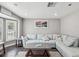 Bright living room features a plush sectional sofa, bay window, and modern decor at 4315 Oakland Dr, New Port Richey, FL 34653