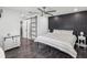 Cozy bedroom boasts a statement wall, ceiling fan, and a sliding barn door to the bathroom at 4315 Oakland Dr, New Port Richey, FL 34653