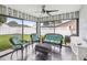 Bright sunroom with wicker seating, surrounded by large windows and a view of the fenced-in backyard at 4315 Oakland Dr, New Port Richey, FL 34653