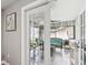 View of sunroom with wicker seating and backyard view from the interior of the house through glass doors at 4315 Oakland Dr, New Port Richey, FL 34653