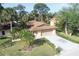 Aerial view of well maintained house with 2 car garage, surrounded by greenery and manicured landscaping at 4328 Marine Pkwy, New Port Richey, FL 34652