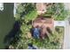 Birds eye view shows the roof, driveway and dock on the canal behind the property at 4328 Marine Pkwy, New Port Richey, FL 34652