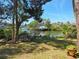 Lush backyard featuring a canal view, mature trees, and waterfront access with boat dock at 4328 Marine Pkwy, New Port Richey, FL 34652